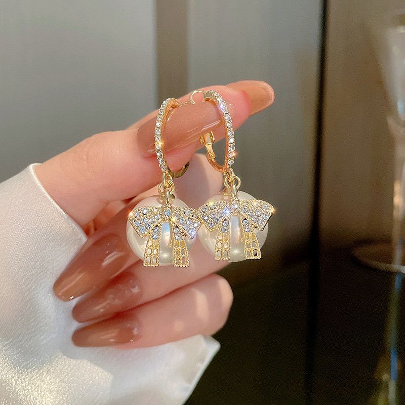 White big pearl bow earring Buy Earrings Online in India | Stylish Earrings for Women & Girls | Korean, Daily Wear, Party Wear, Budget & Premium Jewellery | Oora by Zivya